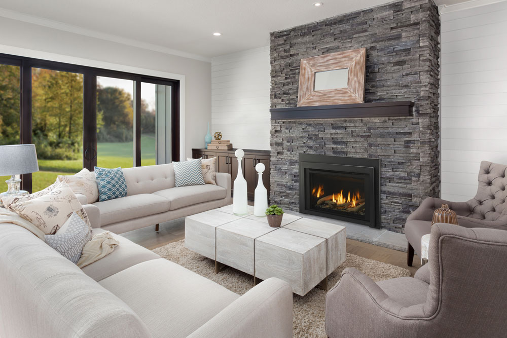 Majestic Ruby gas fireplace insert with black surround in grey stone fireplace