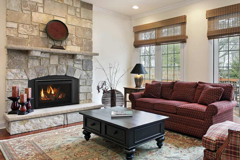 Majestic Ruby gas fireplace insert with black surround in stone fireplace