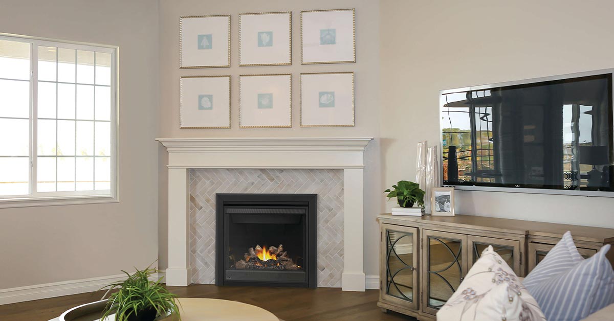 Napoleon Ascent BX 36 gas fireplace with 3" beveled trim set in herringbone tile with white mantel surround in living room setting.