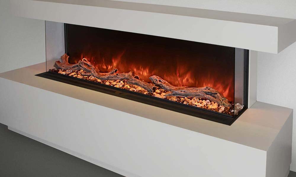 Landscape Pro Multi electric fireplace with three-sided bay installation shown with orange flames and ember bed installed along white wall with white hearth and mantel.