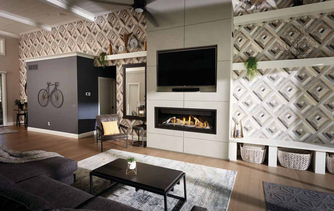 Napoleon Ascent Linear Premium 56 gas fireplace shown burning with optional birch logs in modern loft with geometric wallpapered walls.