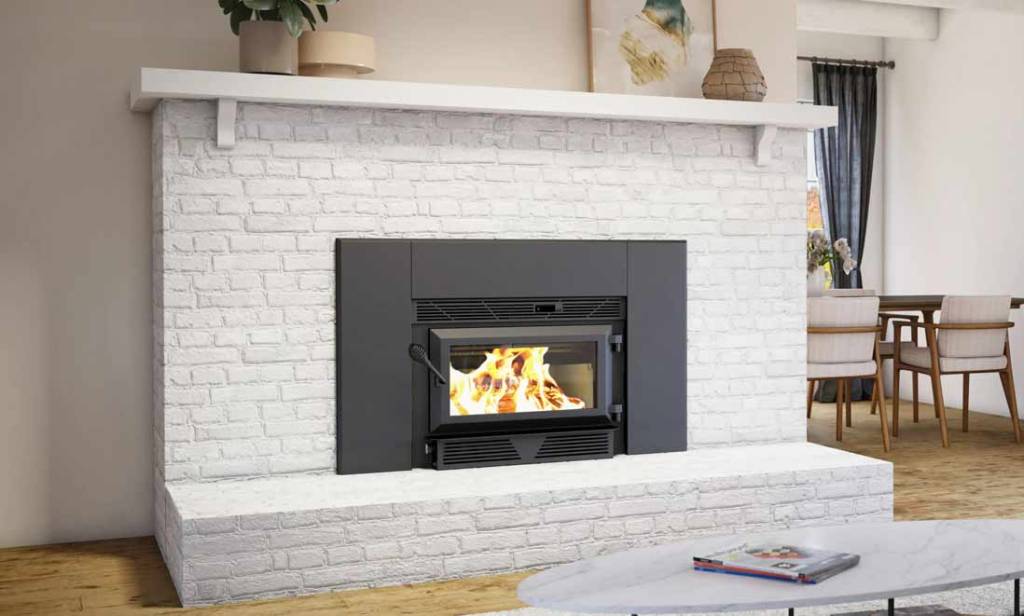 Ventis HEI90 wood fireplace insert with faceplate shown in white brick fireplace in living room