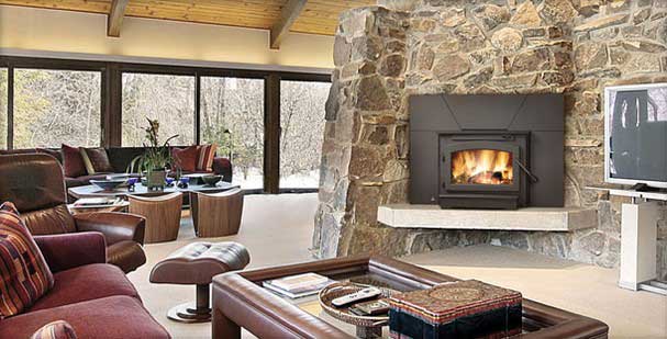 Timberwolf EPI22-1 wood burning fireplace insert with blazing fire in a stone fireplace.