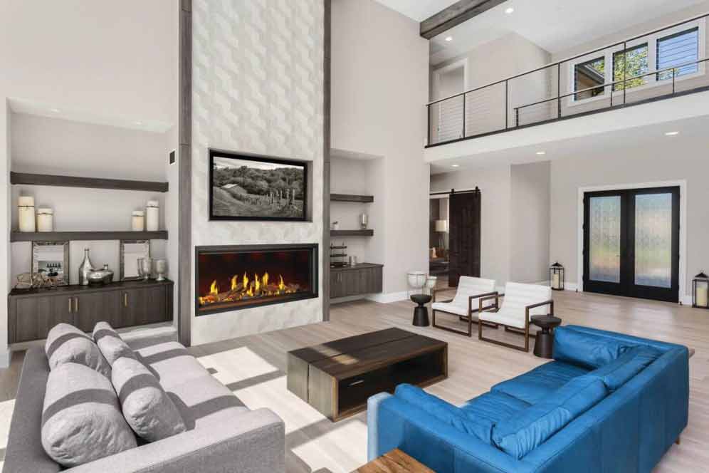 Napoleon Tall Vector gas fireplace with Luminous Logs burning in modern neutral living room with cathedral ceiling, TV above fireplace, gray and bright blue sofas