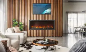 Napoleon Astound electric fireplace on wood slat wall with TV above in living room with white furniture, round table, and a white and black rug.